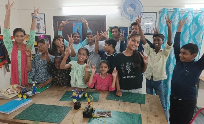 Students smiling and posing for photos at ApniPathshala learning